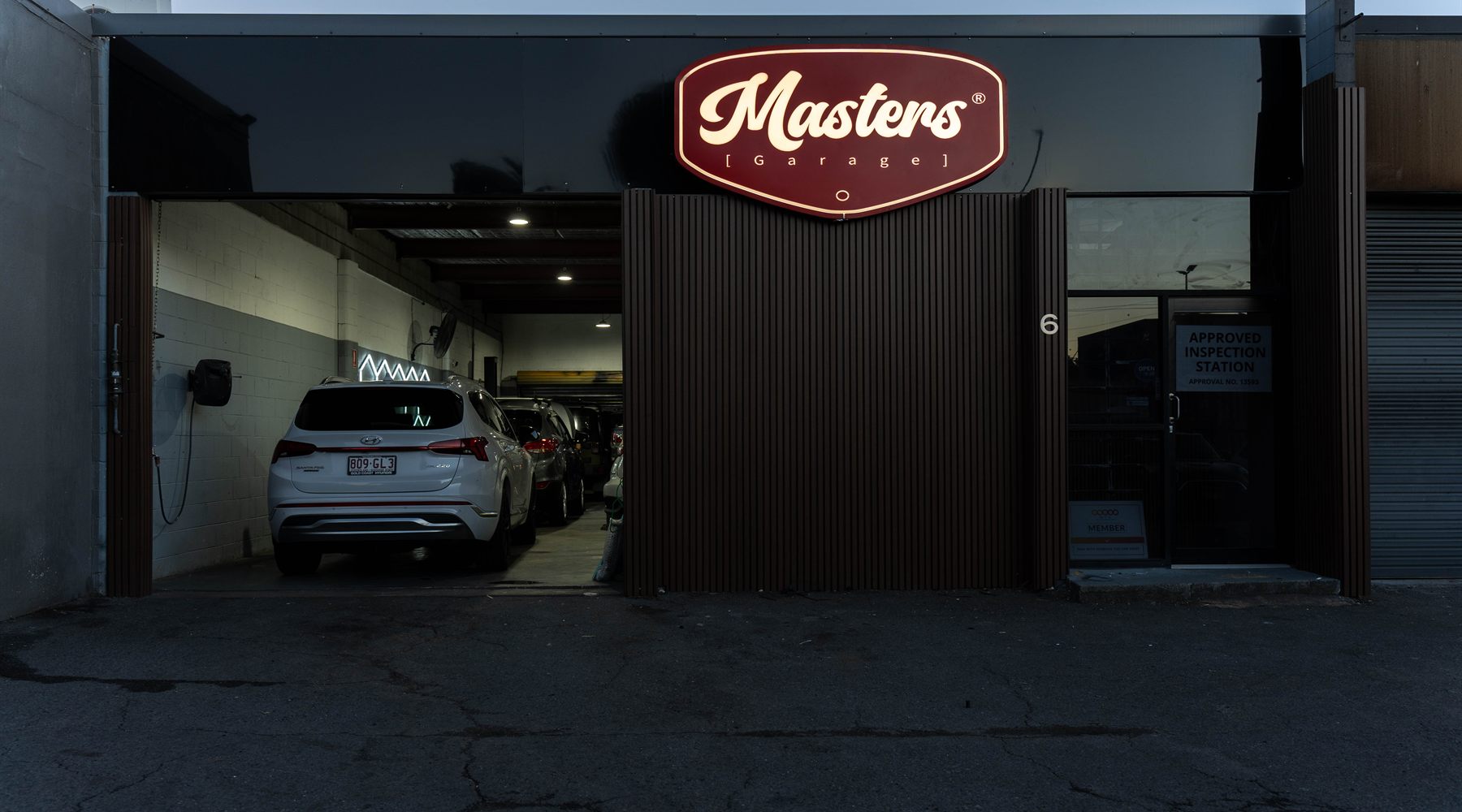 Masters Garage workshop entrance and illuminated sign, Ferry Rd Southport